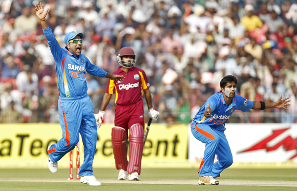 India's Vinay Kumar (right) and his teammate Rohit Sharma (left) appeal successfully for the wicket of West Indies' Adrian Barath in the 1st ODI