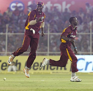 Darren Sammy (left) celebrates with Kemar Roach after winning the 3rd ODI