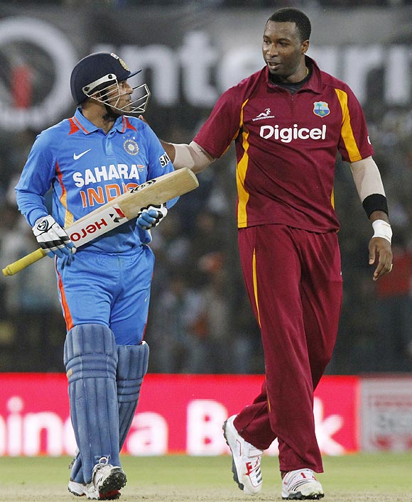 India's captain Virender Sehwag (left) is congratulated by West Indies' Kieron Pollard after scoring 200 runs