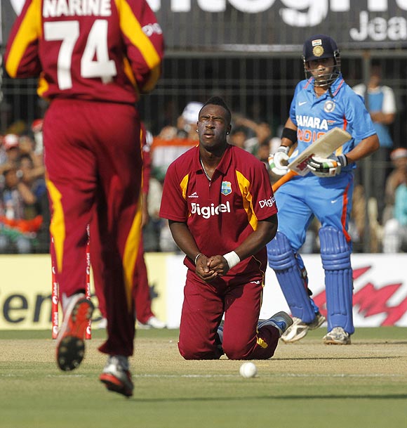 West Indies's Andre Russell reacts after dropping a catch off the bat of India's Gautam Gambhir
