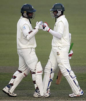 Bangladesh's Shahriar Nafees (left) congratulates teammate Shakib Al Hasan after he scored a century against Pakistan on Saturday