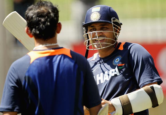 Virender Sehwag (right) chats to team-mate Gautam Gambhir