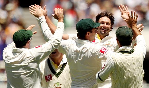 Ben Hilfenhaus of Australia is congratulated by team-mates after getting the wicket of Gautam Gambhir