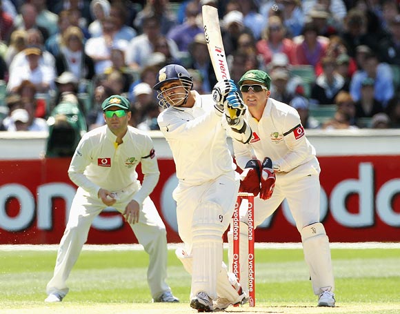 Virender Sehwag hits out as Michael Clarke (left) and Brad Haddin look on
