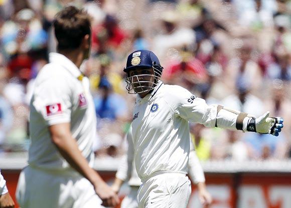 Virender Sehwag exchanges a few words with James Pattinson