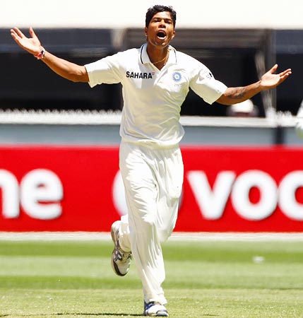 Umesh Yadav celebrates after taking the wicket of Shaun Marsh