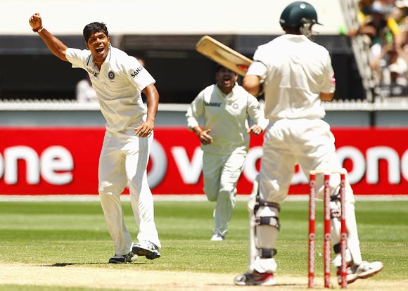 Umesh Yadav is jubilant after taking the wicket of Ed Cowan
