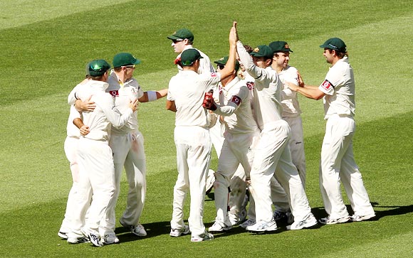 The Australian team celebrate winning the first Test in Melbourne