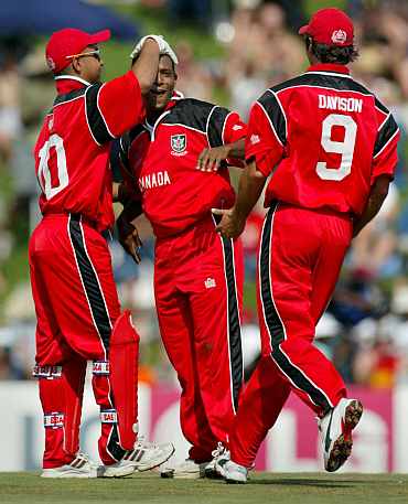 Canadian players celebrate after picking up a wicket