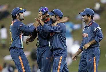 Virat Kohli celebrates with team-mates after a fall of a wicket