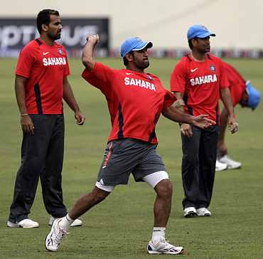 MS Dhoni throws the ball during a practice session in Dhaka