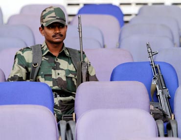 Security personnel watch the 2011 World Cup warm-up match between Zimbabwe and Ireland in Nagpur