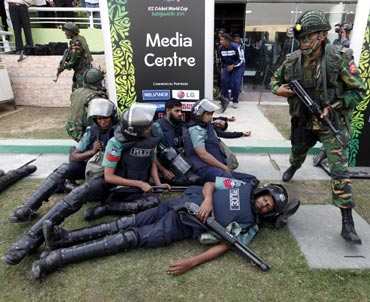 Security personnel take part in an emergency drill after a simulated blast at a stadium in Dhaka