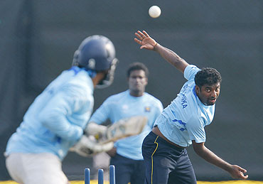Sri Lanka's Muttiah Muralitharan bowls to Tillakaratne Dilshan during a practice session in Hambantota district on Friday