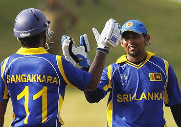 Sri Lanka's Tillakaratne Dilshan (right) celebrates with captain Kumar Sangakkara after scoring a half century against Canada on Sunday