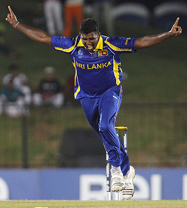 Sri Lanka's Thisara Perera celebrates taking the wicket of Canada's John Davison