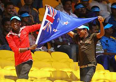 New Zealand fans wave the flag during the match against Kenya