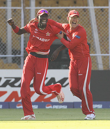 Chris Mpofu (left) celebrates with teammate Charles Coventry after running out Ricky Ponting