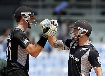 New Zealand's Brendon McCullum and Martin Guptill celebrates after winning the match against Kenya
