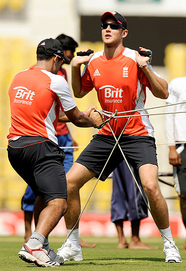 England's Stuart Broad (right) stretches with team-mate Ravi Bopara during a training session in Nagpur on Monday