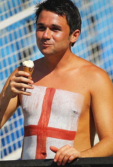 A English supporter enjoys an ice cream during the match between England and Netherlands on Tuesday
