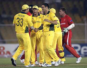 Australian players celebrate after winning the match against Zimbabwe in Ahmedabad