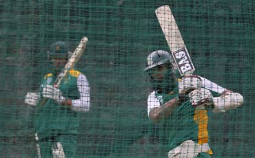 Hashim Amla (R) bats in the nets as his captain Graeme Smith watches