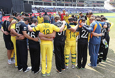 The New Zealand and Australian teams share a moment in support of victims of the earthquake