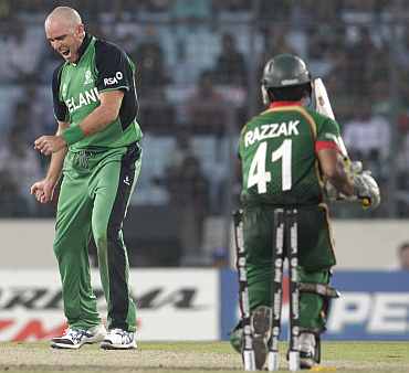Ireland's Trent Johnston (L) celebrates after dismissing Bangladesh's Abdur Razzak