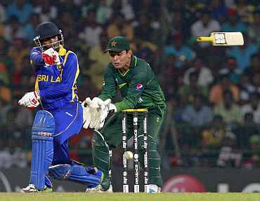 Chamara Silva's bat flies out of his hands as he tries to hit a shot during the World Cup match