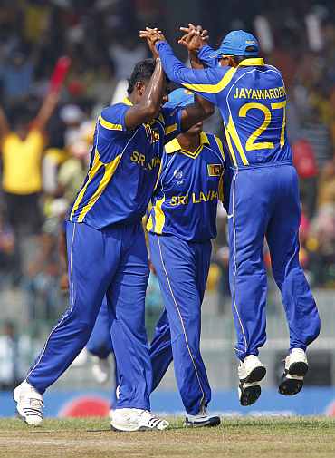 Sri Lankan players celebrate after picking up the wicket of Ahmed Shehzad