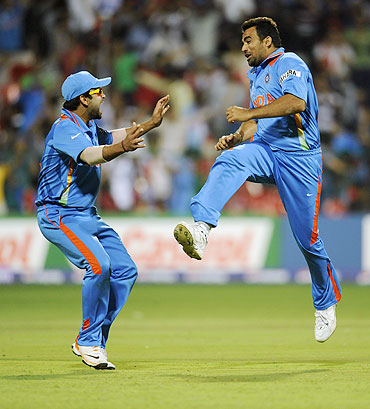 India's Zaheer Khan (right) celebrates with teammate Virat Kohli after dismissing Andrew Strauss