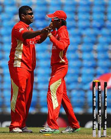 Canada's Balaji Rao is congratulated by Nitesh Kumar during the World Cup Group A game between Canada and Zimbabwe