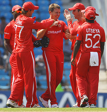 Ray Price is congratulated by teammates after dismissing Canada's Nitish Kumar