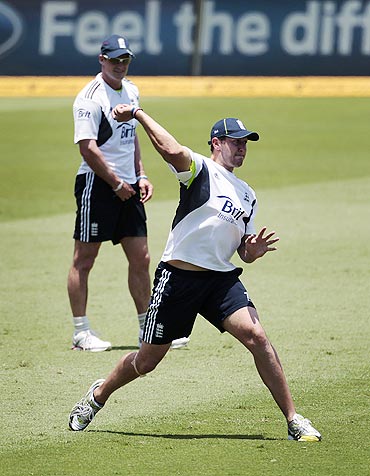 England's captain Andrew Strauss (back) watches Tim Bresnan during a team fielding practice session on Sunday