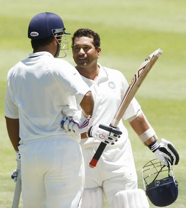 Tendulkar celebrates with M S Dhoni after getting to his hundred