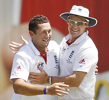 Andrew Strauss (right) congratulates Tim Bresnan for claiming the wicket of Hughes on Thursday