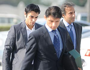 Salman Butt (left) arrives in Doha to record his statement