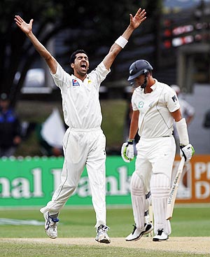 Pakistan's Umar Gul celebrates after claiming the wicket of New Zealand's Brent Arnel (right) on day four of the second Test in Wellington on Tuesday