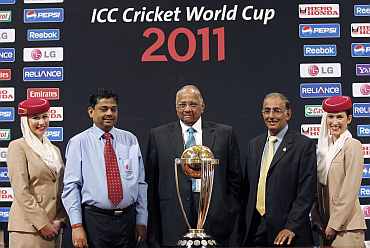 ICC President Sharad Pawar, ICC CEO Haroon Lorgat and ICC Cricket World Cup 2011 Tournament Director Proff. Ratnakar Shetty pose with 2011 Cricket World Cup trophy in Mumbai