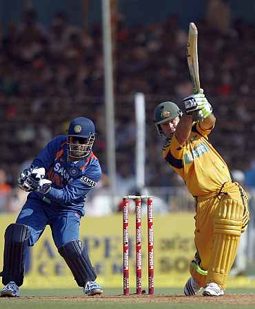 Ricky Ponting plays a shot as India's MS Dhoni looks on