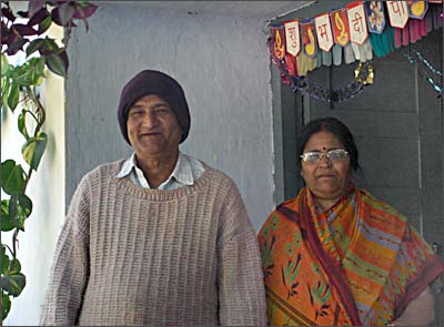 Dhoni's parents Pan and Devki Singh in front of their home in Ranchi