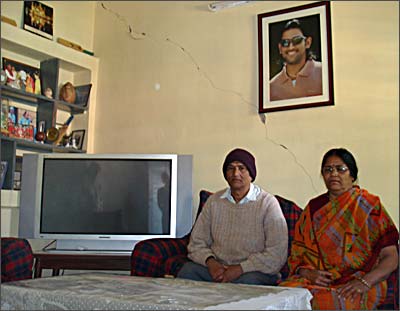 Pan and Devki Singh next to the television Dhoni bought them to watch his matches