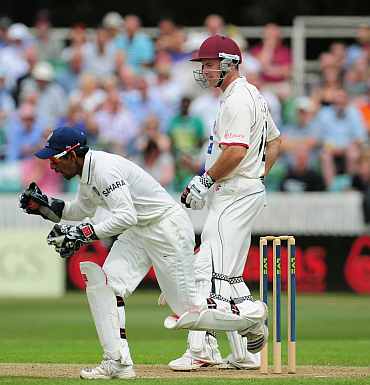 Andrew Strauss is caught by wicketkeeper Wriddhiman Saha during day one of the tour match between Somerset and India