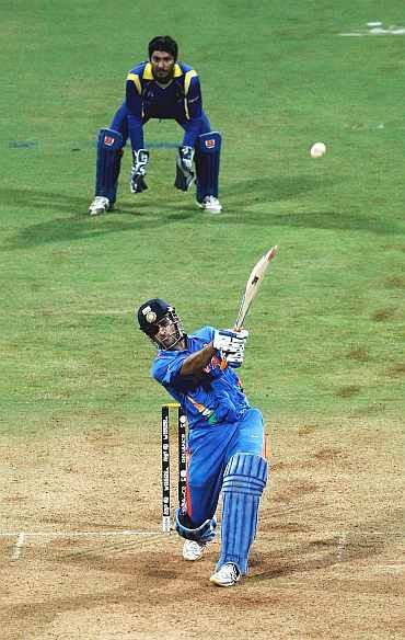 Mahendra Singh Dhoni hits Kulasekara over long-on for a six to seal victory in the World Cup final at the Wankhede stadium
