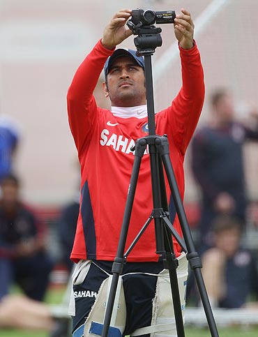 MS Dhoni sets up a camera during the India nets session