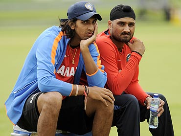 India's Ishant Sharma (left) and Harbhajan Singh take a break during a training session