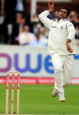 Mahendra Singh Dhoni bowls on Day 2 of the first Test