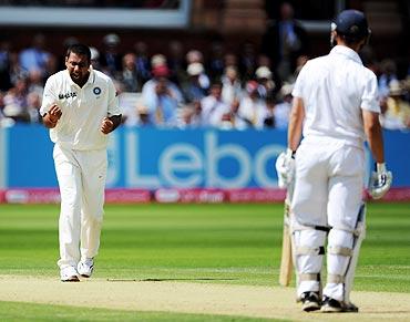 Praveen Kumar (left) celebrates after dismissing Jonathan Trott (right)