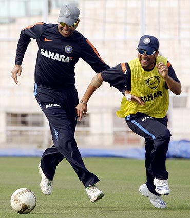 VVS Laxman (left) plays football with Sachin Tendulkar during a training session